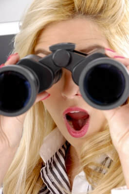 woman spying with binoculars